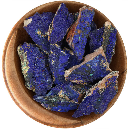 Bowl of rough natural Azurite crystals on a flat piece of matrix rock. The Azurite is a brilliant blue with tiny crystals, the matrix rock is mostly tan, with minor inclusions of black, green, and yellow from other minerals.