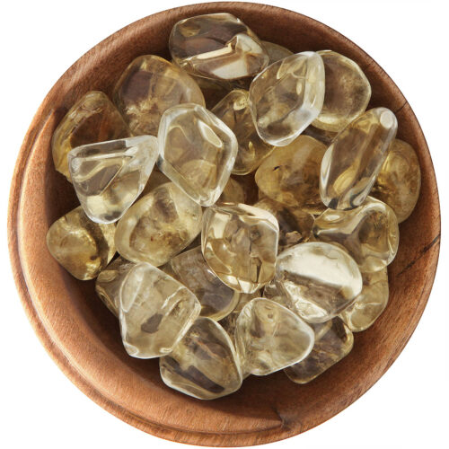 Bowl of tumbled natural Citrine. Yellow, transparent, irregularly shaped smooth stones.