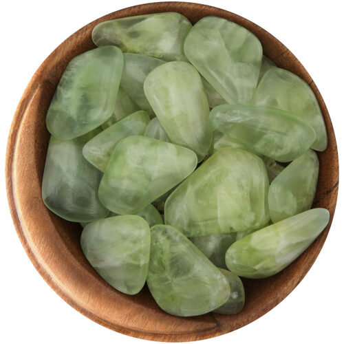 Bowl of polished high-quality Prehnite. Irregular shapes, polished into cabochons, rounded on one side, flat on the other. Bright lime green color